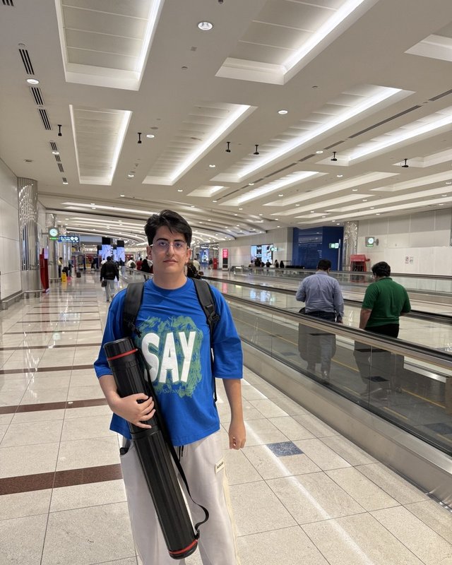 Raman Nafarieh carrying the research poster tube while travelling to ISIF 2025