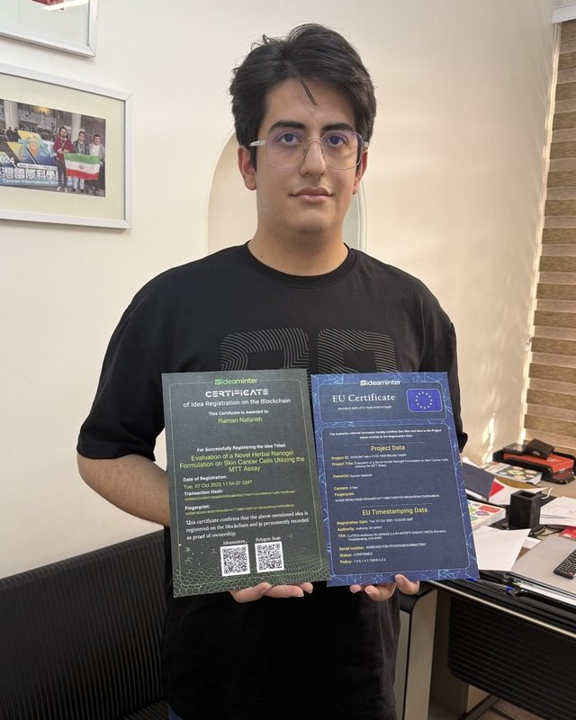 Raman Nafarieh holding the blockchain idea registration and EU Trusted Timestamp certificates